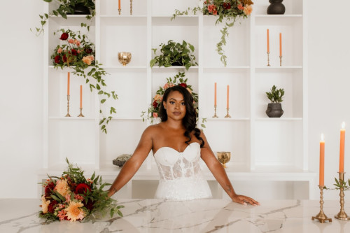 Bride with flowers behind a table