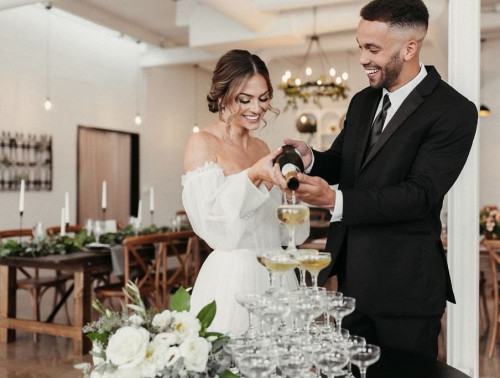 Bride and groom pouring champaign