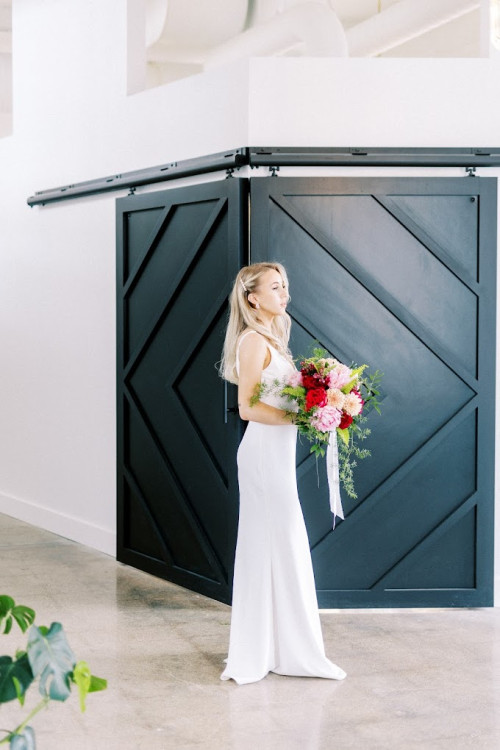 Bride holding flowers inside 600 East Events